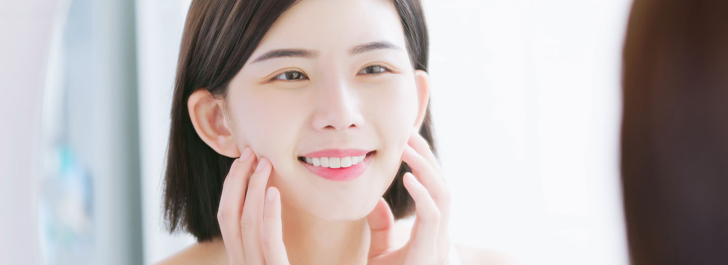 笑顔で鏡を見る女性